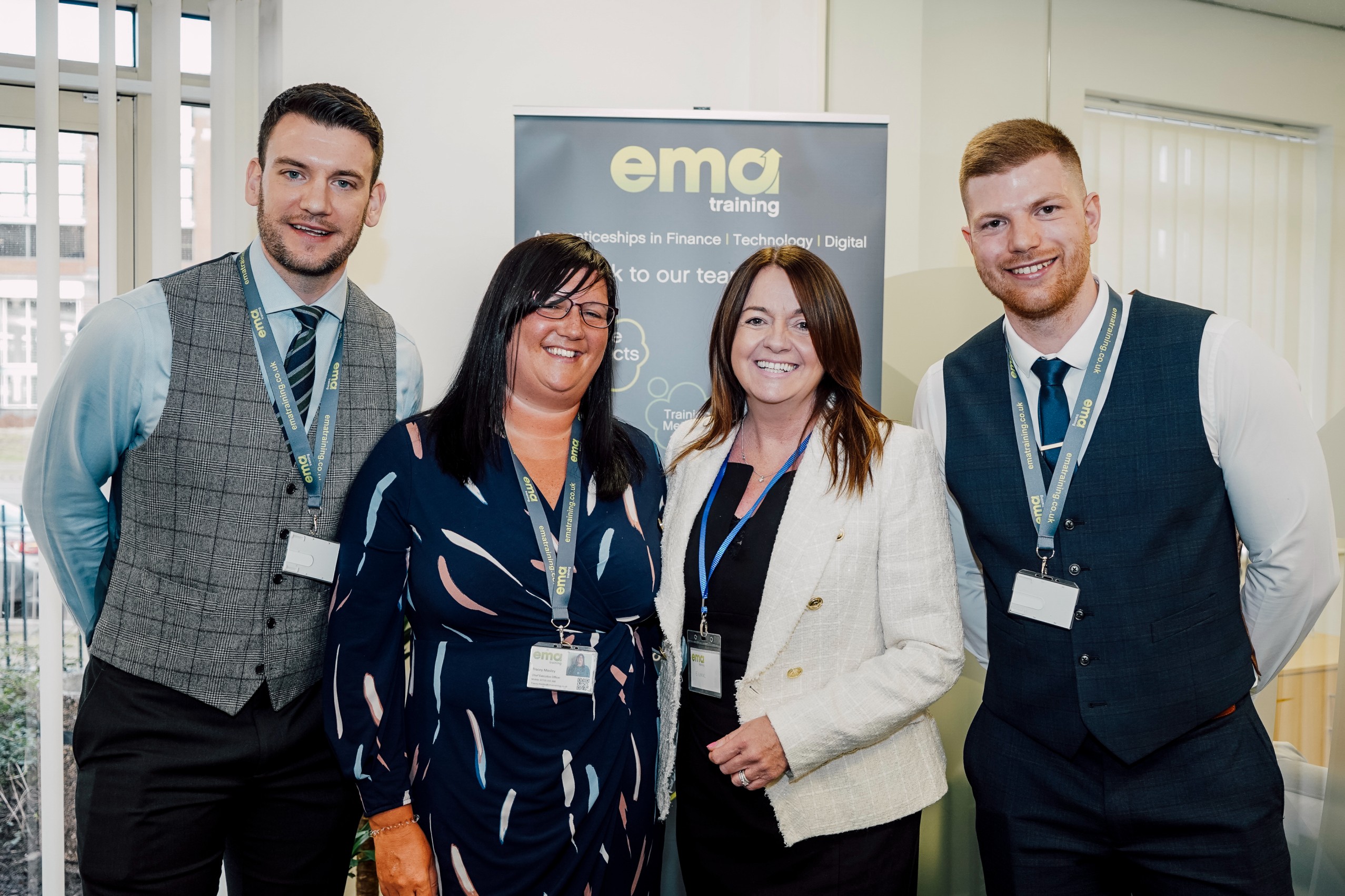 EMA's James Stafford, Tracey Mosley, Matt Edwards with Eileen Richards, MBE, smiling in EMA Training's new office.