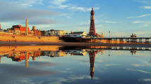 A Fylde Coast Golden Hour Reflection of Blackpool Tower and North Pier on a calm still early evening glow.