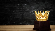 image of golden crown award over wooden table.