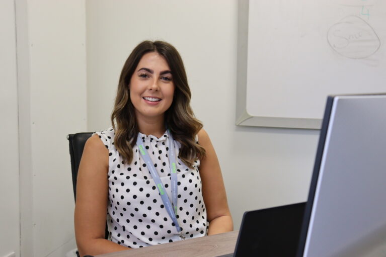 EMA Training's Business Development Manager, Caitley, at her desk in the Digital Training Hub in Derby City Centre. Caitley's main role is to support Employers in hiring an apprentice.