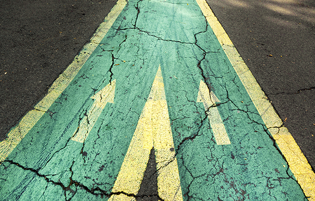 Close up arrow signs on asphalt city road