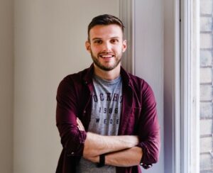 Harry Jones, Global Head of Recruitment and Talent, Bam Boom Cloud, smiling with his arms crossed.