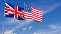 United Kingdom and USA flags over blue sky background. 3D illustration